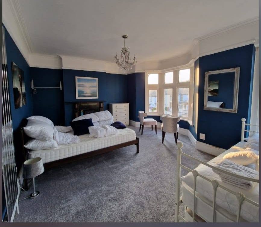 Guest bedroom finished in soft teal